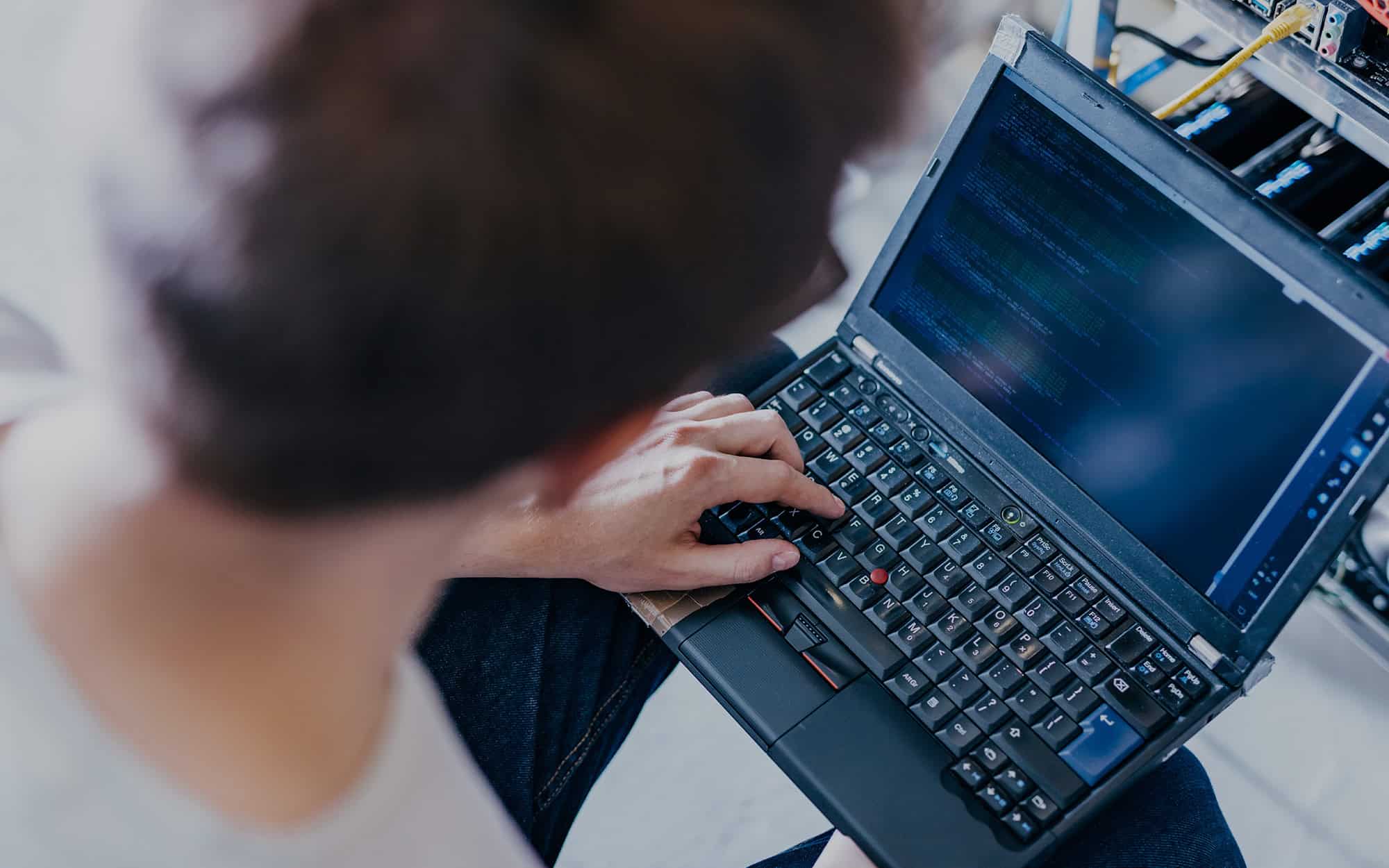 Top Down View Of An It Professional Typing On Laptop