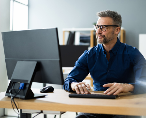 Worker Using Computer In Office