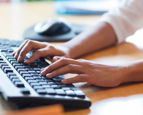 Close Up Of Female Hands Typing On Keyboard